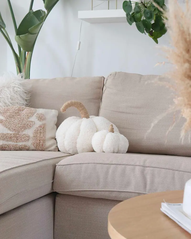 White boucle pumpkin pillows on a beige sofa