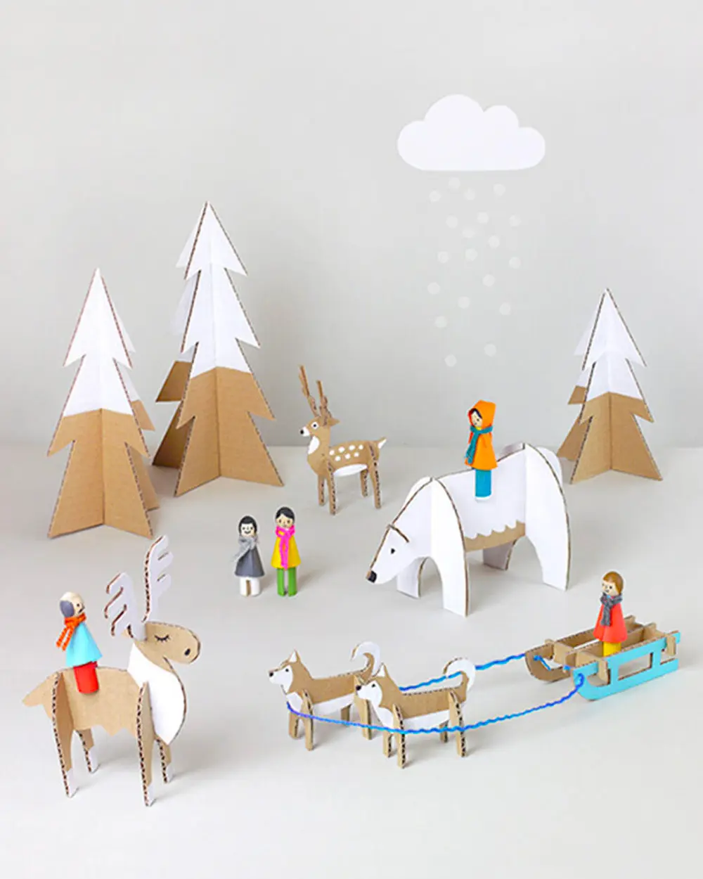 Cardboard snowy scene with trees, polar bear, reindeer sled and peg-doll figures