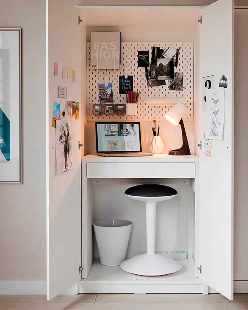 Cupboard office with pegboard, mood board, lamp and white stool