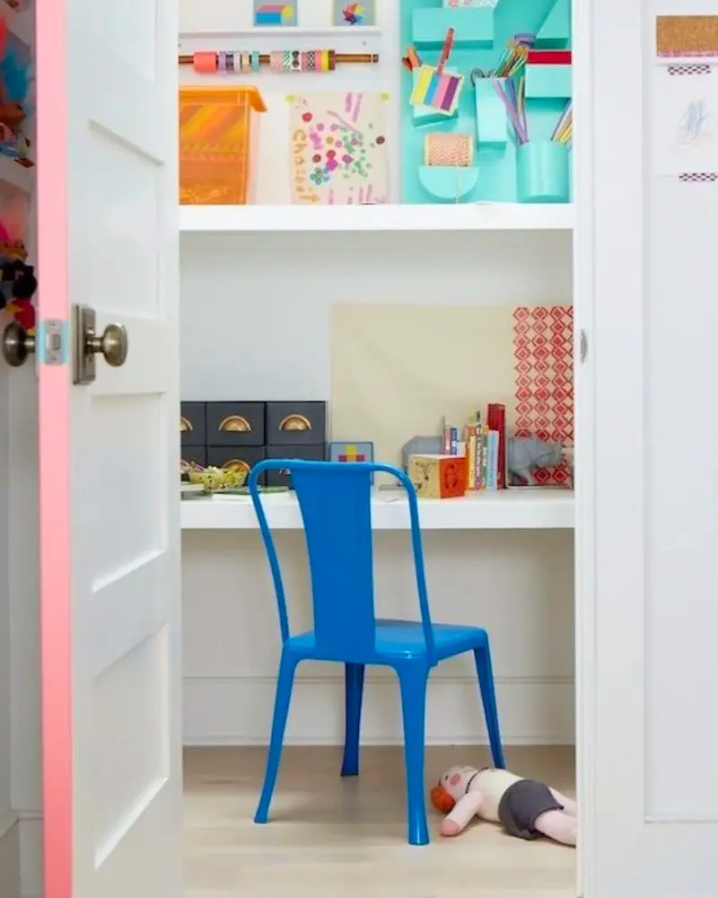 Closet desk with blue metal chair and colorful wall organizers