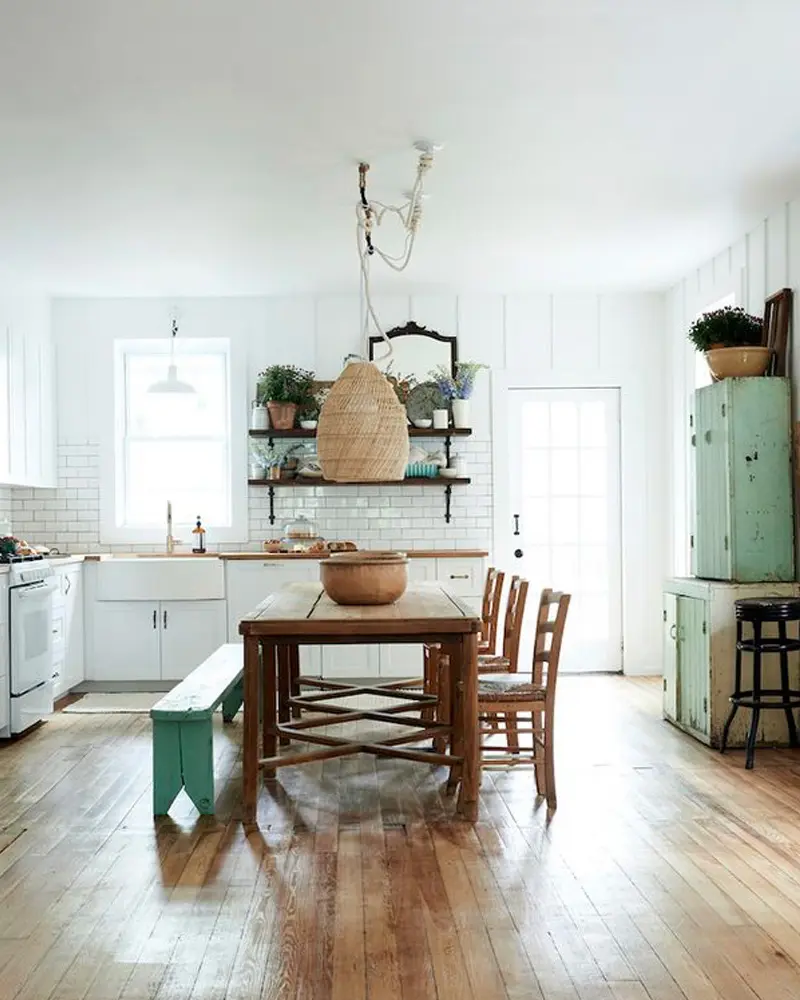 Farmhouse wood table with green bench, rattan pendant and mint vintage cabinet