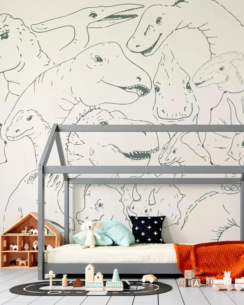 Kids room with line-drawn dinosaur mural, gray house bed frame and orange throw