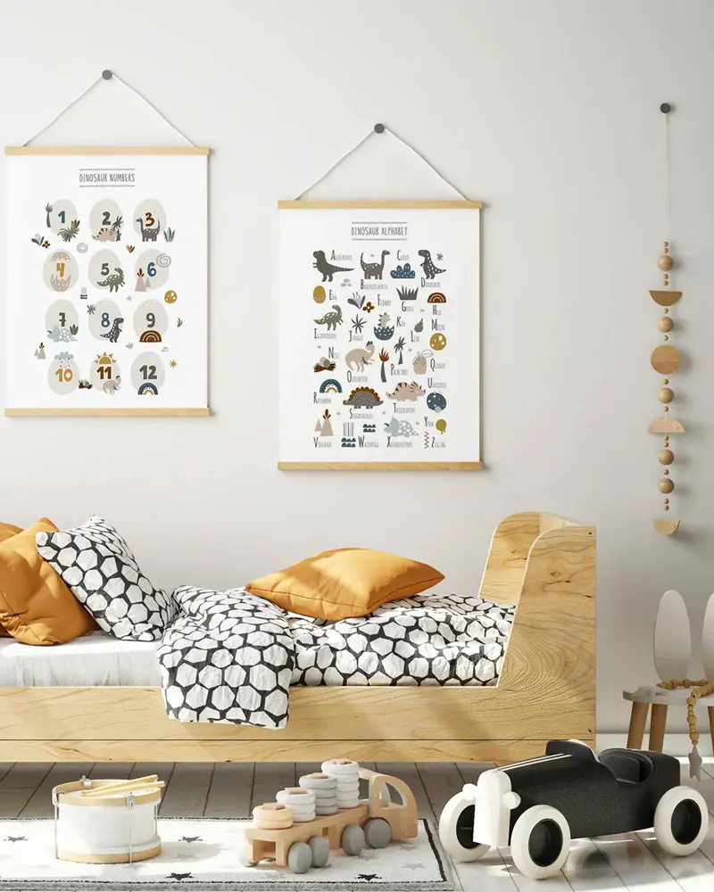 Kids room with two dinosaur alphabet and number posters above a wooden bed