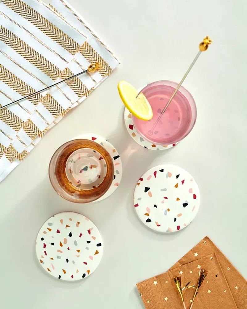 Round white terrazzo coasters under glasses of pink lemonade
