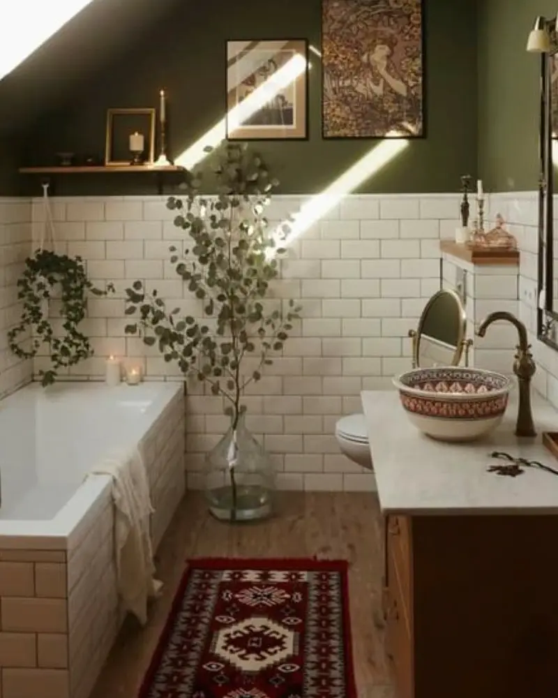Bathroom with olive green upper walls, white subway tile, a built-in tub, eucalyptus in a glass vase and a red patterned rug