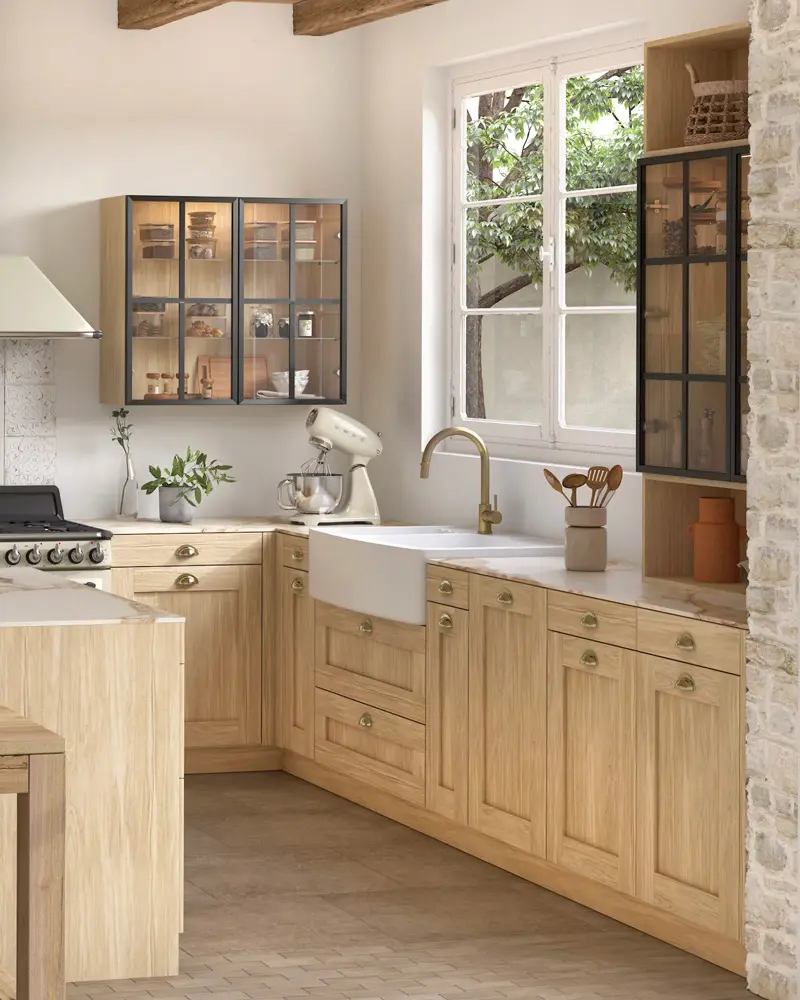 Light oak shaker cabinets, a glass-front wall cabinet and an apron sink in an all-wood kitchen