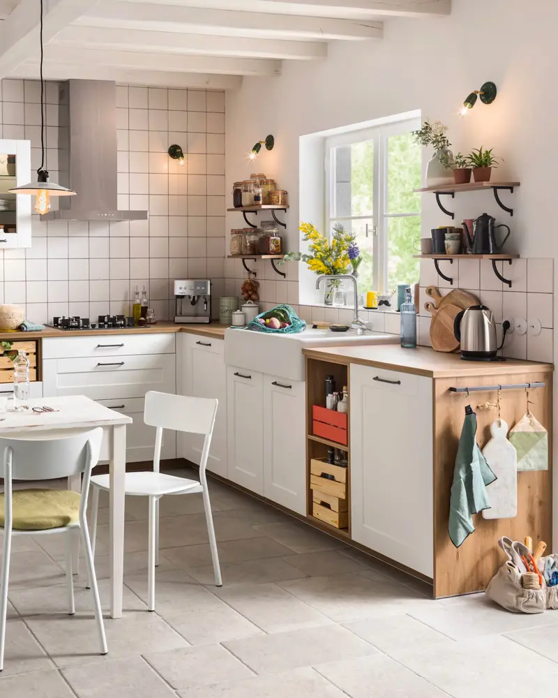 White square tile, a wood-fronted base unit with hanging tea towels and a white table and chairs