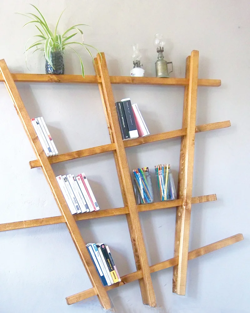 Leaning wood strip bookshelf with angled uprights holding books