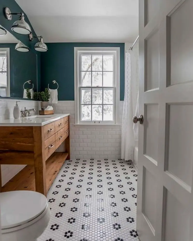 Bathroom with a teal accent wall, a wood double vanity, white subway tile and a black and white hexagon floor