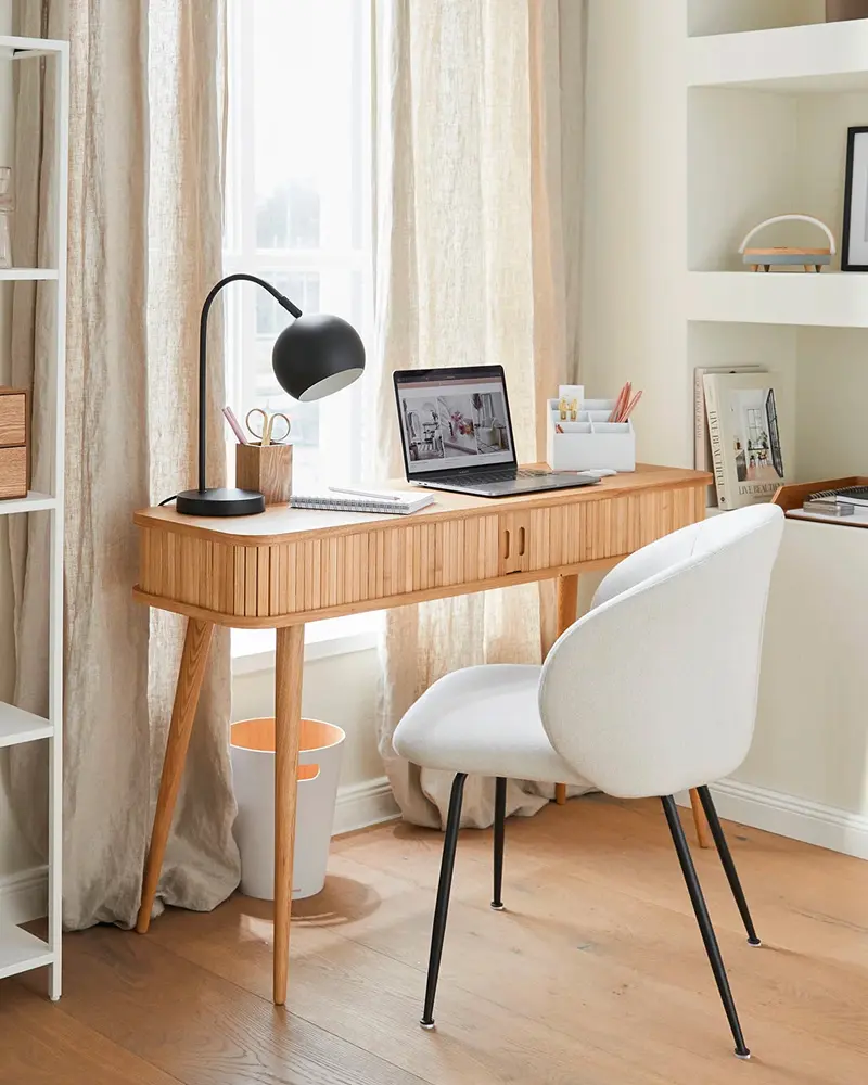 Reeded wood console desk with white boucle chair, black dome lamp and sheer curtains