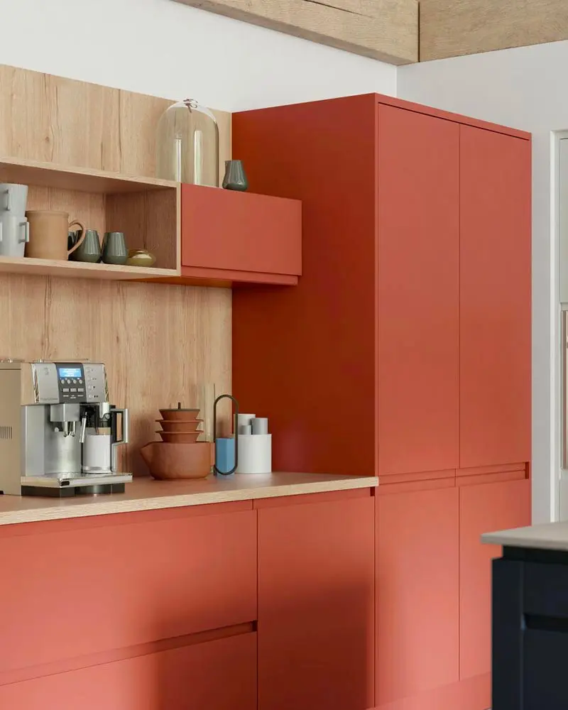 Kitchen with terracotta cabinets and light wood open shelving