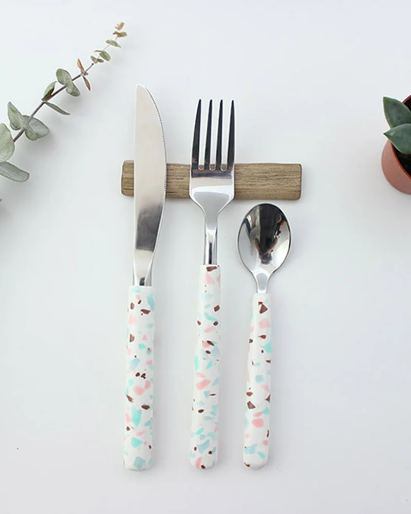 Knife, fork and spoon with white polymer clay handles flecked with pastel chips