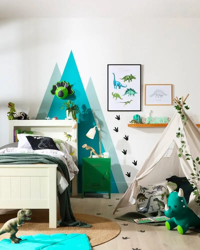 Kids room with painted teal mountains, dinosaur posters, green nightstand and teepee