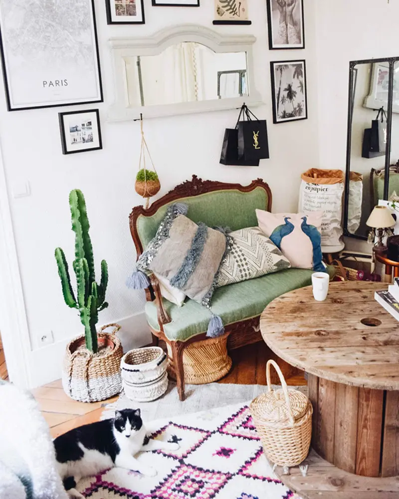 Green velvet antique settee, cable spool table, cactus in a basket and pink Berber rug