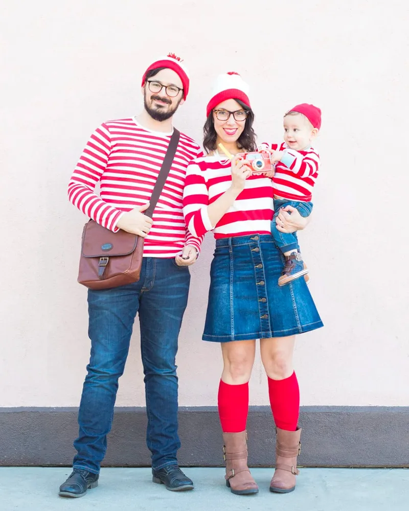 Family dressed as Waldo characters in red and white striped shirts, bobble hats and glasses